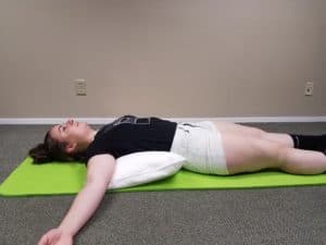 Myofascial Self Treatment extending spine over a pillow