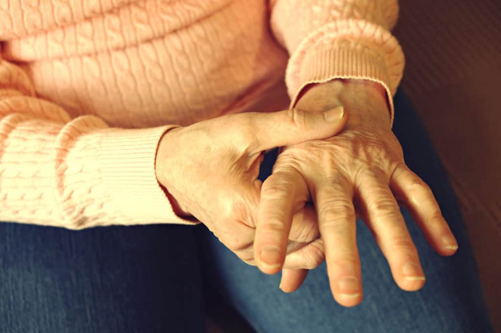 Close up of mature womans hands. Health care giving, nursing home. Parental love of grandmother. Old age related diseases.