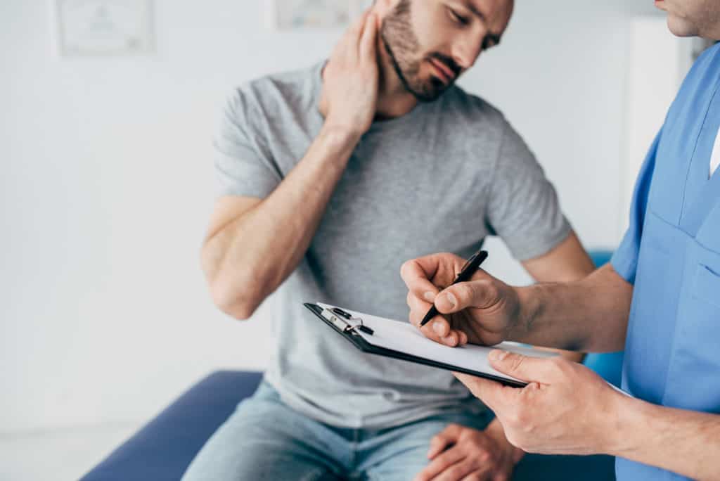 doctor seeing patient with neck pain