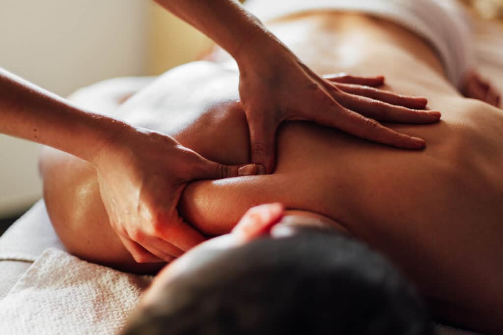 Close-up of masseur's hands massaging a client's back